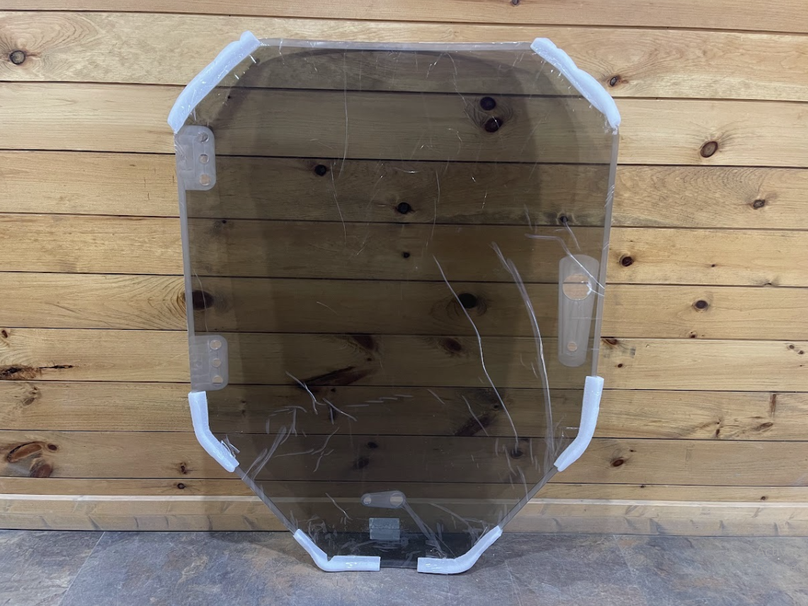 Tinted Bobcat R Series polycarbonate windshield with white rubber door seal gasket installed around perimeter