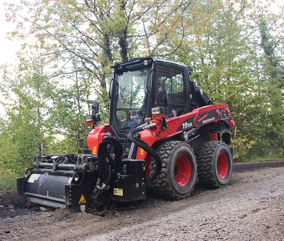 Eurocomach 19SK wheeled skid steer with forestry mulcher attachment on a jobsite road