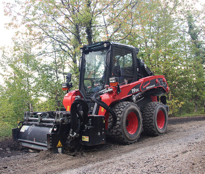 Eurocomach 19SK wheeled skid steer with forestry mulcher attachment on a jobsite road