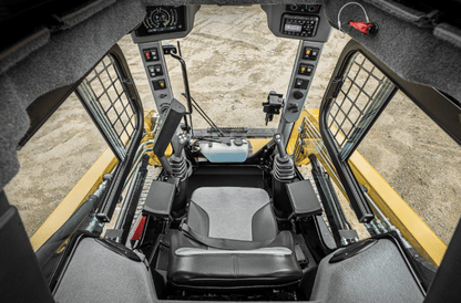 Interior view of ASV Max-Series skid steer cab showing operator seat, joystick controls, and forward visibility through polycarbonate windshield