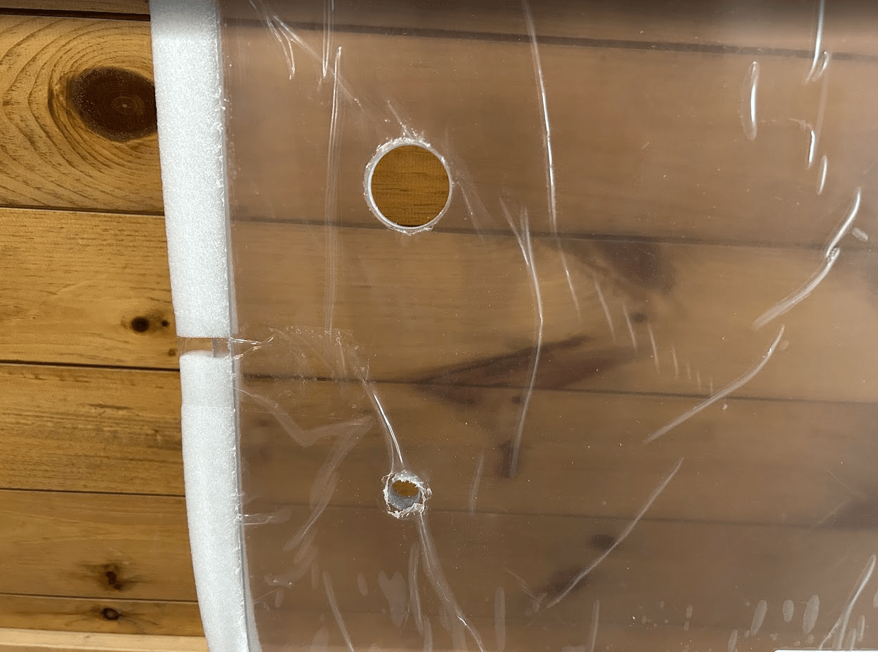 Close-up detail of ASV Max-Series polycarbonate windshield showing pre-drilled mounting holes and foam edge seal strip