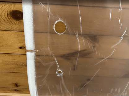 Close-up detail of ASV Max-Series polycarbonate windshield showing pre-drilled mounting holes and foam edge seal strip