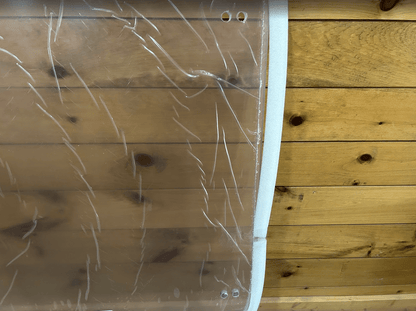 Top edge detail of ASV Max-Series polycarbonate windshield showing foam edge seal strip and upper mounting hole positions