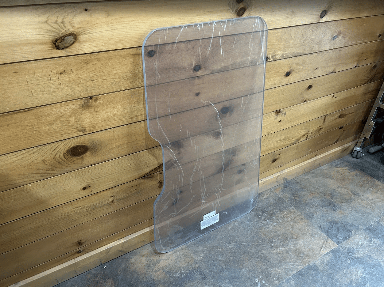ASV PosiTrack RC85 RC100 clear polycarbonate windshield showing full shape with distinctive notched lower profile, angled view