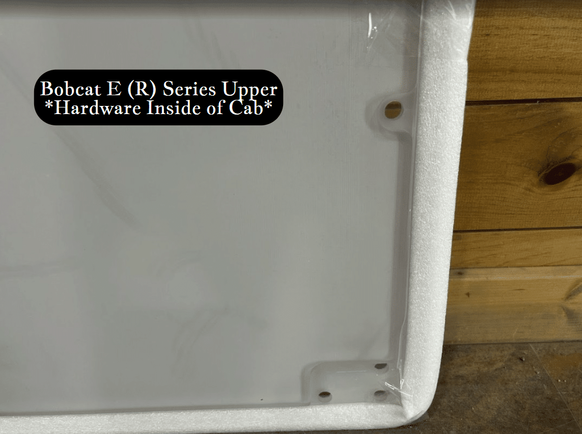 Corner detail of Bobcat E (R) Series upper excavator windshield showing pre-drilled mounting holes and white foam perimeter seal