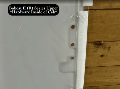 Close-up detail of Bobcat E (R) Series upper windshield edge showing foam seal and mounting stud hardware on the side
