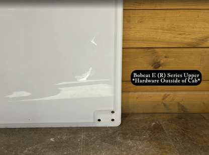 Bottom corner detail of Bobcat E (R) Series upper windshield exterior side showing mounting holes and foam seal edge
