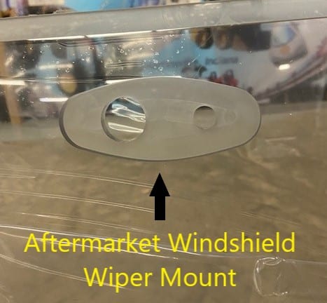 Close-up of Bobcat G Series aftermarket polycarbonate windshield showing the wiper mount location, annotated with yellow text overlay