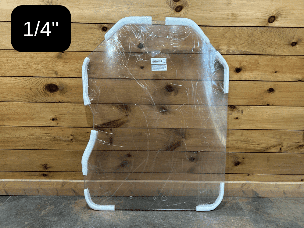 Bobcat G Series 1/4 inch thick polycarbonate windshield replacement with protective white edge frame, shown against wooden wall