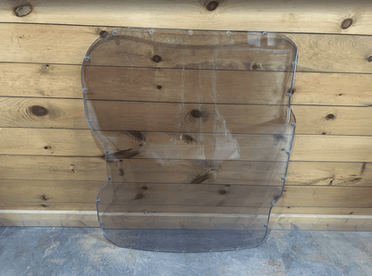 Bobcat M Series 3/4 inch laminated polycarbonate forestry windshield replacement - full front view against wooden background