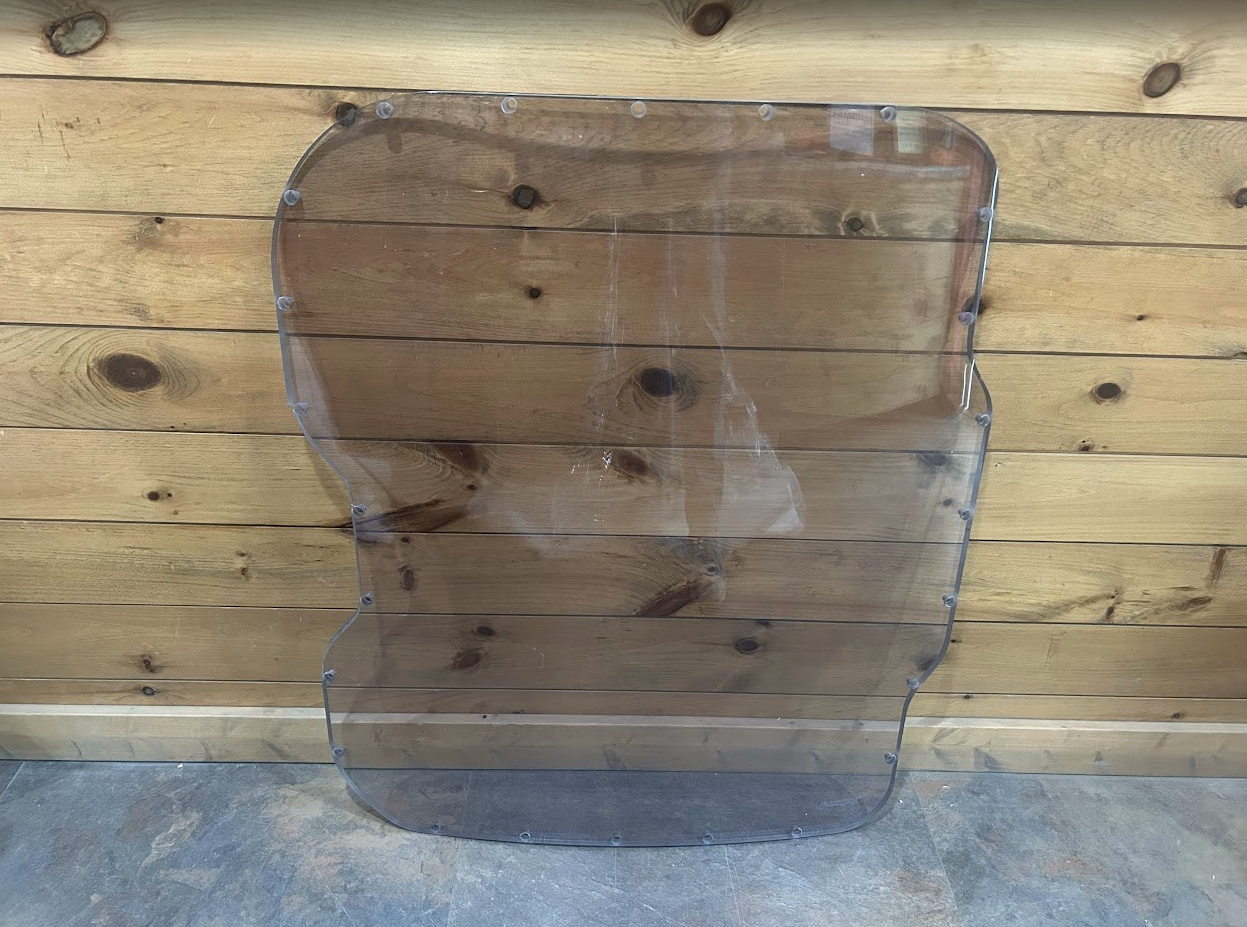 Bobcat M Series 3/4 laminated polycarbonate forestry windshield OEM #7193293, straight-on front view showing full piece