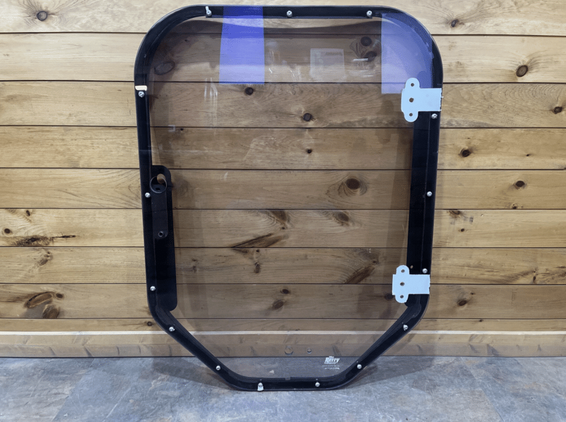 Bobcat M Series steel frame and polycarbonate windshield replacement, front view against wood background