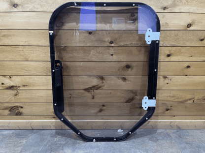 Bobcat M Series steel frame and polycarbonate windshield replacement, front view against wood background