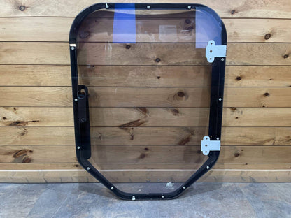 Bobcat M Series steel frame and polycarbonate windshield replacement showing hinge side, front view on wood background