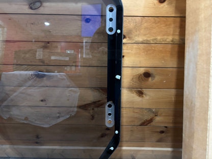 Bobcat R Series door frame right side panel close-up showing mounting adjustment slots and polycarbonate panel edge