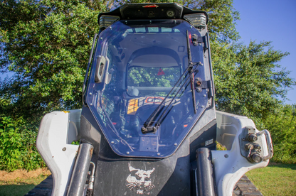 Bobcat R Series skid steer with new frame and windshield assembly installed, overhead exterior view outdoors