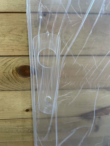 Side view of Bobcat R Series polycarbonate windshield showing mounting hole cutout on clear panel