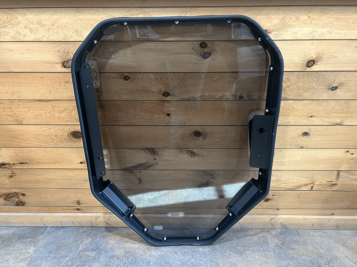 Bobcat S86 T86 R Series windshield replacement with clear glass and black frame, showing full unit from a slightly angled view