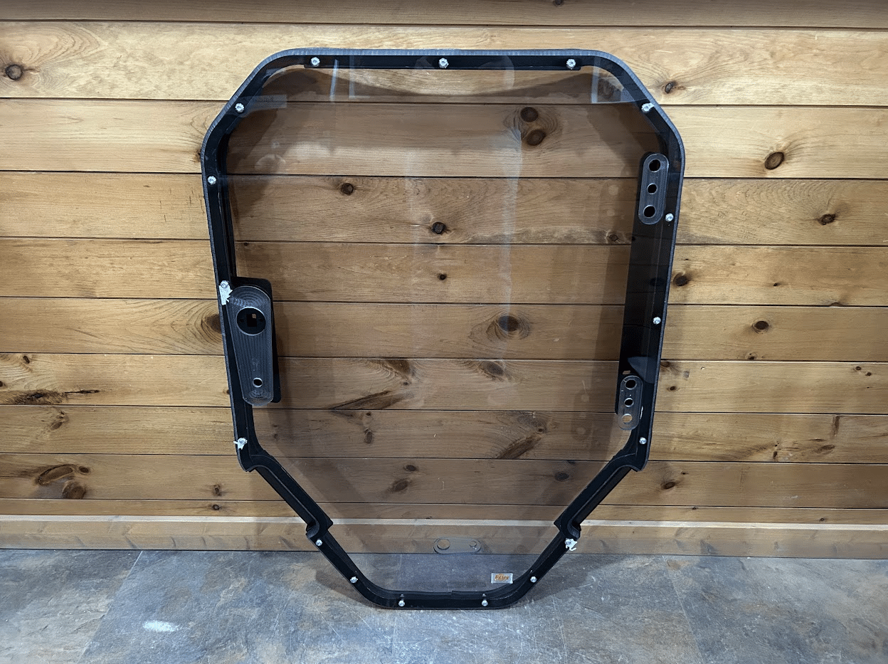 Bobcat S86 T86 R Series skid steer windshield frame replacement - front view with black frame and clear polycarbonate glass
