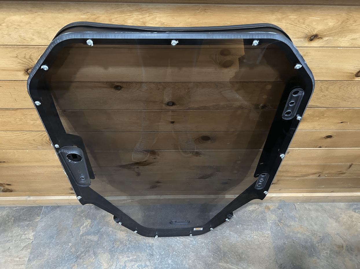 Bobcat S86 T86 R Series windshield replacement with tinted dark glass and black frame - tinted variant front view