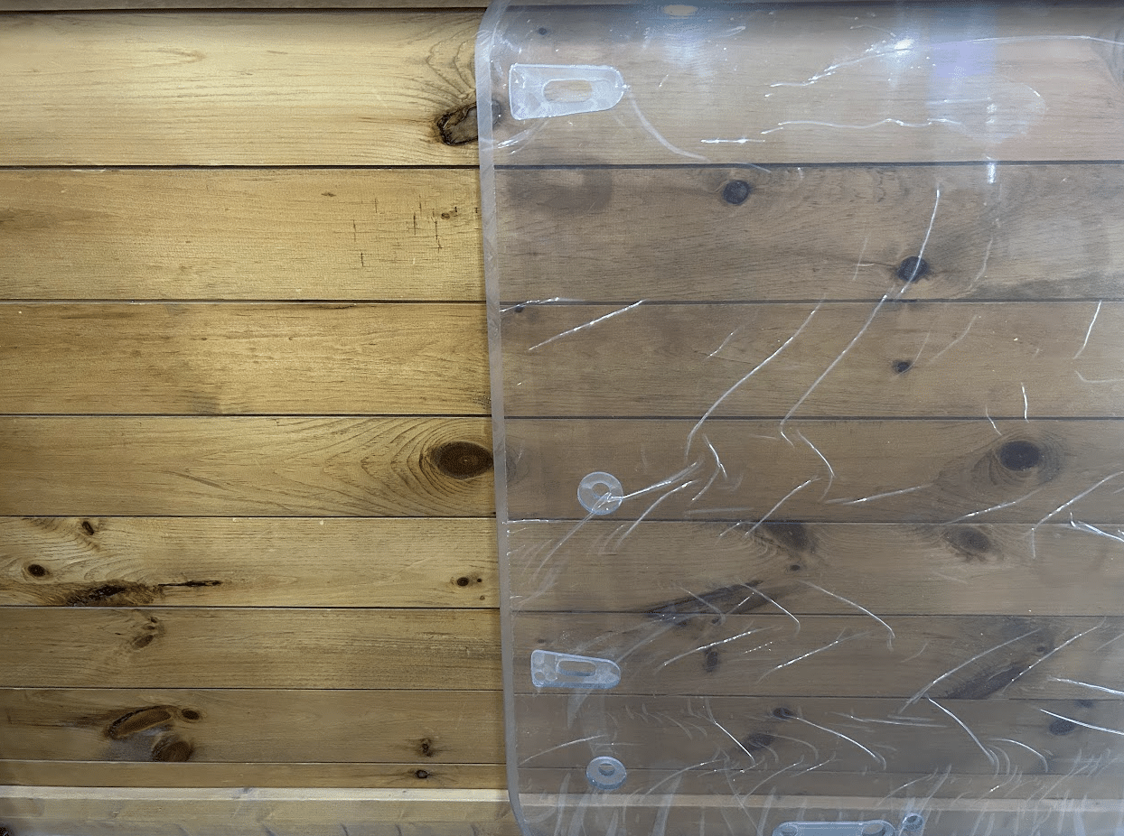 Close-up of the right side edge and mounting tabs on the Case DL550 TV620B Minotaur polycarbonate windshield