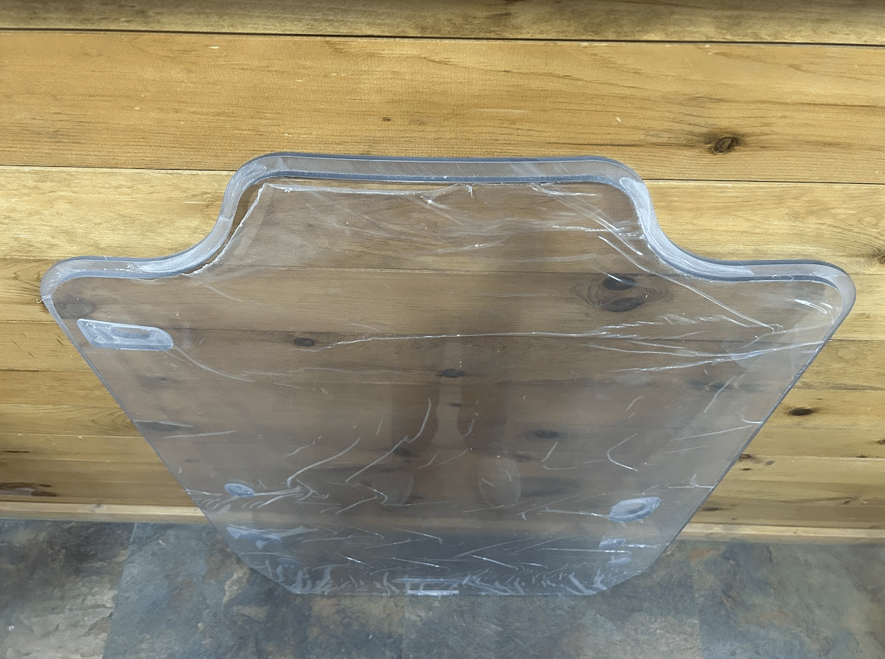 Close-up of the top edge of the Case DL550 TV620B Minotaur polycarbonate windshield showing the distinctive notched shape