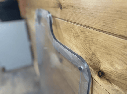Close-up of Case/New Holland forestry door showing precision milled polycarbonate frame edge and mounting tab