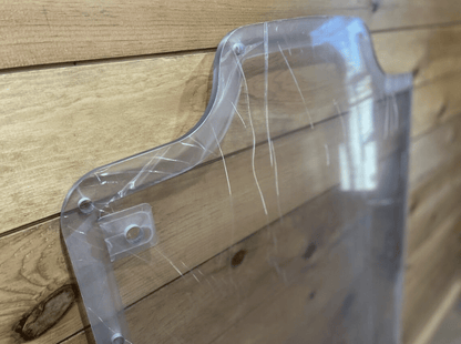 Top corner of Case/New Holland polycarbonate forestry door replacement showing bolt holes and milled frame edge