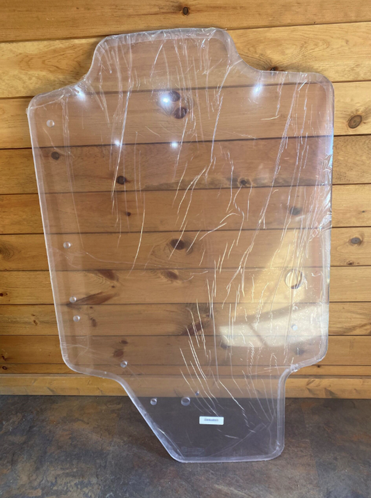 Case SR TR SV TV Series clear polycarbonate windshield panel with protective film, shown on wooden surface