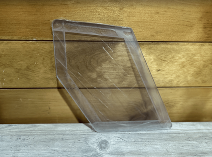 Case SR TR SV TV Series thick polycarbonate windshield half-door panel shown at an angle on wooden surface, clear with protective film