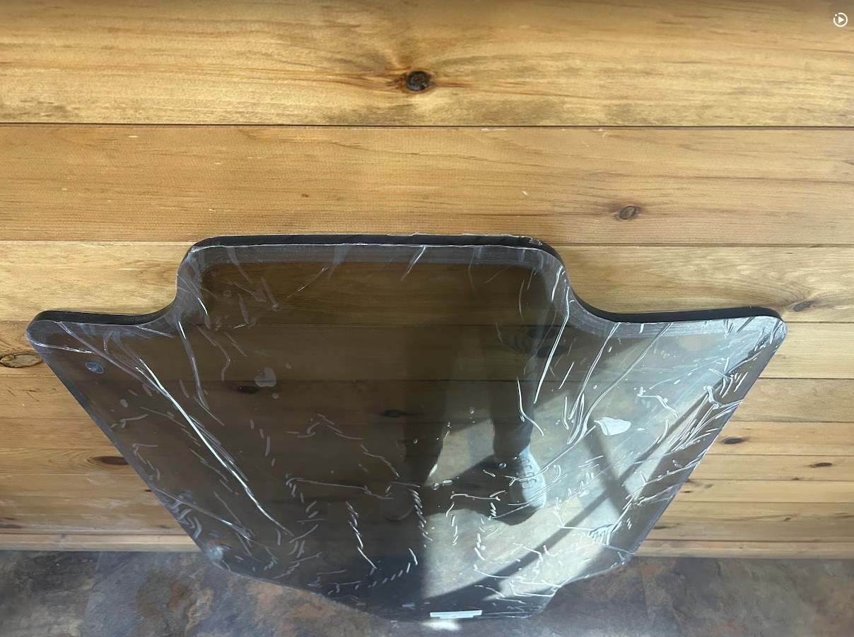 Case SR TR SV TV Series tinted polycarbonate windshield bottom wiper mounting area, panel laid flat with protective film