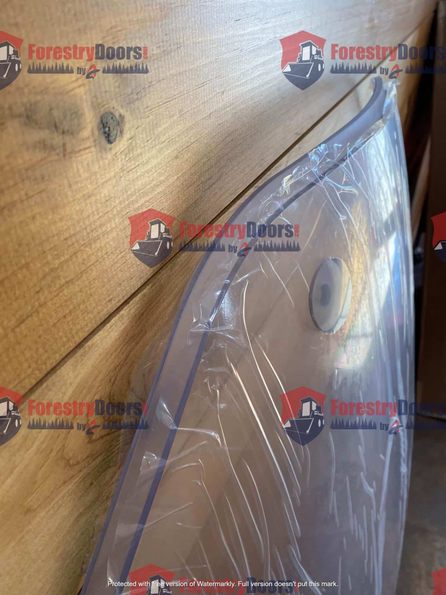 Side profile view of Caterpillar C Series polycarbonate windshield panel showing edge thickness and mounting hole