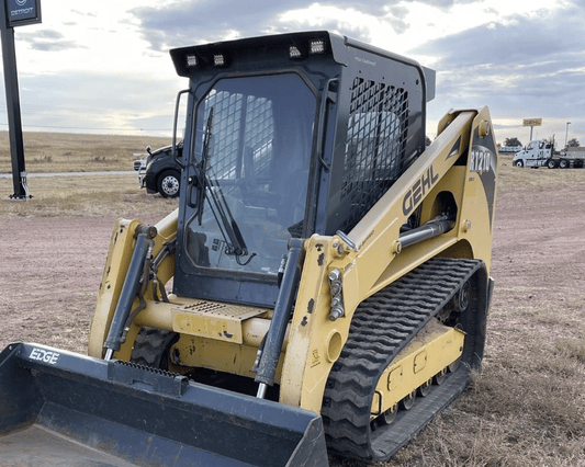 Gehl RT210 compact track loader with existing windshield glass shown outdoors in a field, front-left angle