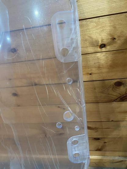 Close-up of right-side hinge tabs and holes on John Deere D Series polycarbonate windshield replacement