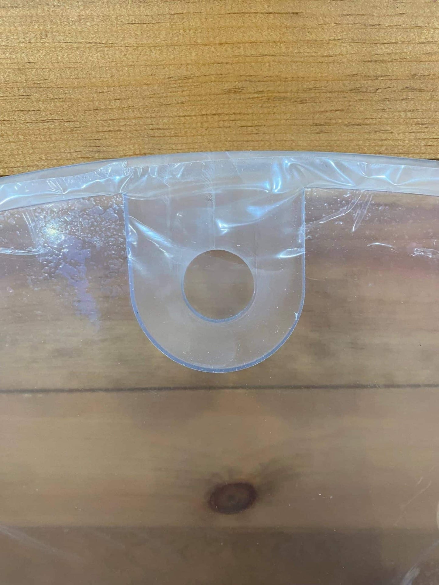 Extreme close-up of U-shaped top hinge slot on John Deere D Series polycarbonate windshield replacement