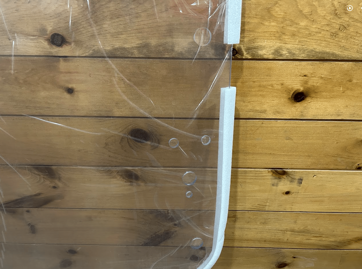 Close-up of the white right side frame and mounting holes on John Deere G Series small frame polycarbonate windshield