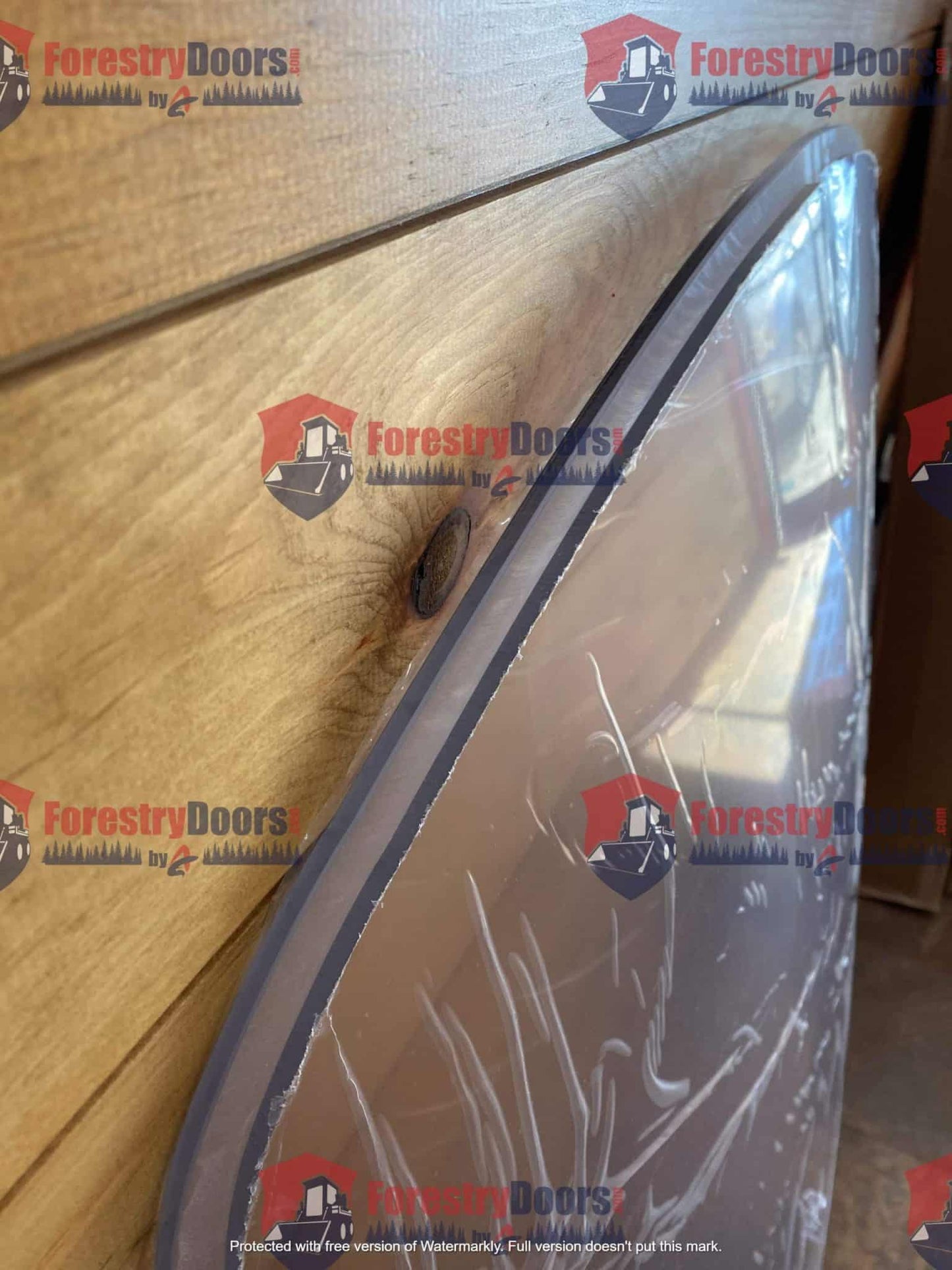Close-up of curved top edge of John Deere G Series small frame polycarbonate windshield with edge seal in wrap