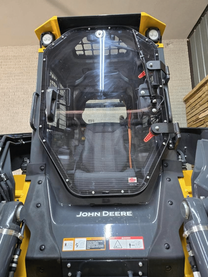 John Deere P Series skid steer front view showing polycarbonate windshield frame replacement installed on machine
