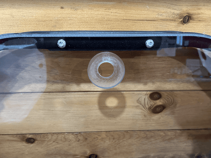 Close-up of top center of John Deere P Series windshield frame showing mounting grommet and frame bolts