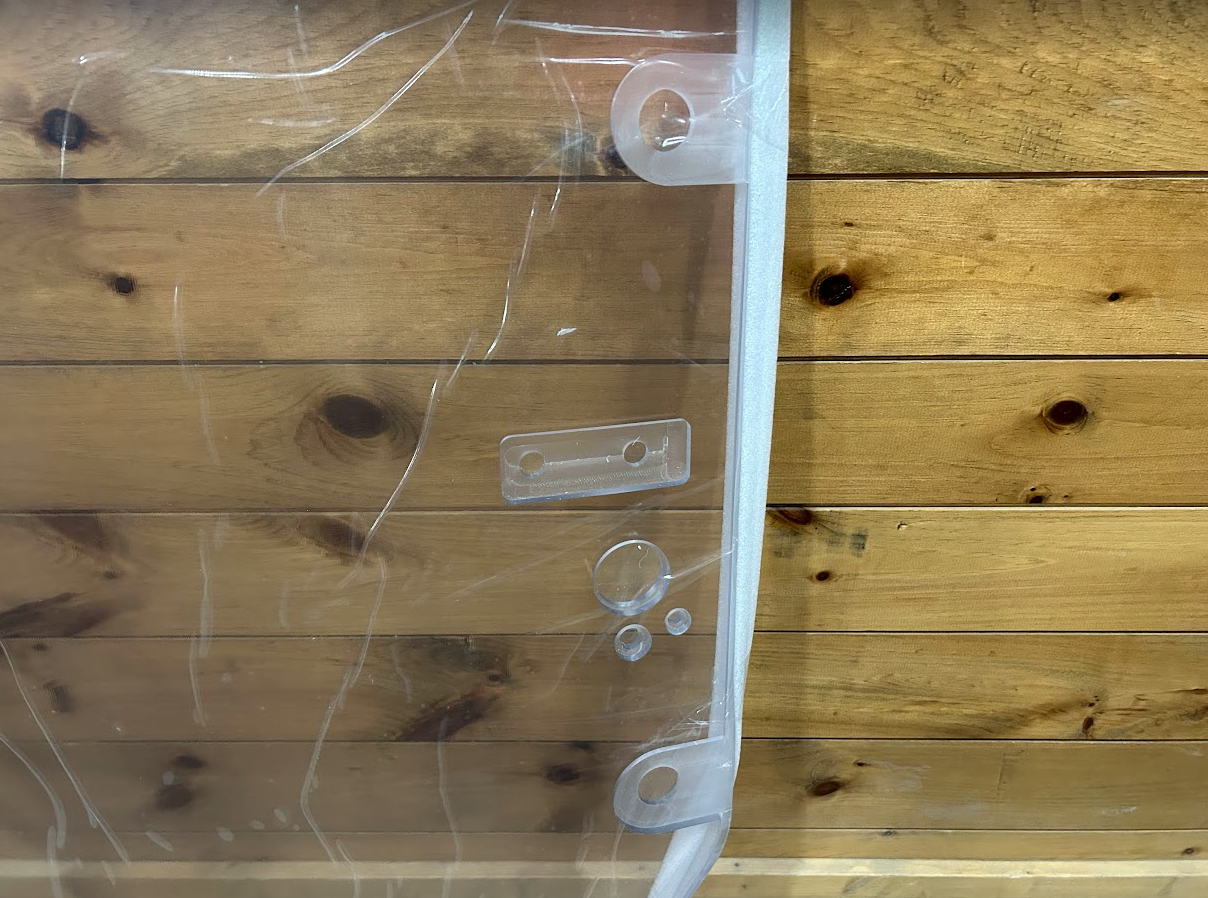 John Deere P Series windshield right side edge showing white frame and mounting hole hardware