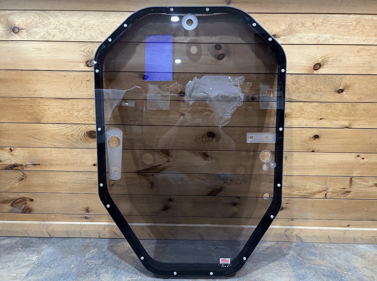 John Deere P Series tinted polycarbonate windshield with black metal frame assembly, front view