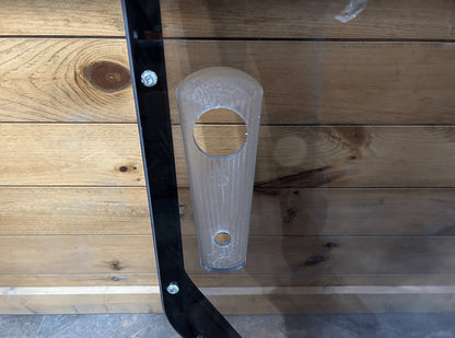 Close-up of tinted John Deere P Series windshield frame left side showing clear polycarbonate pull latch handle