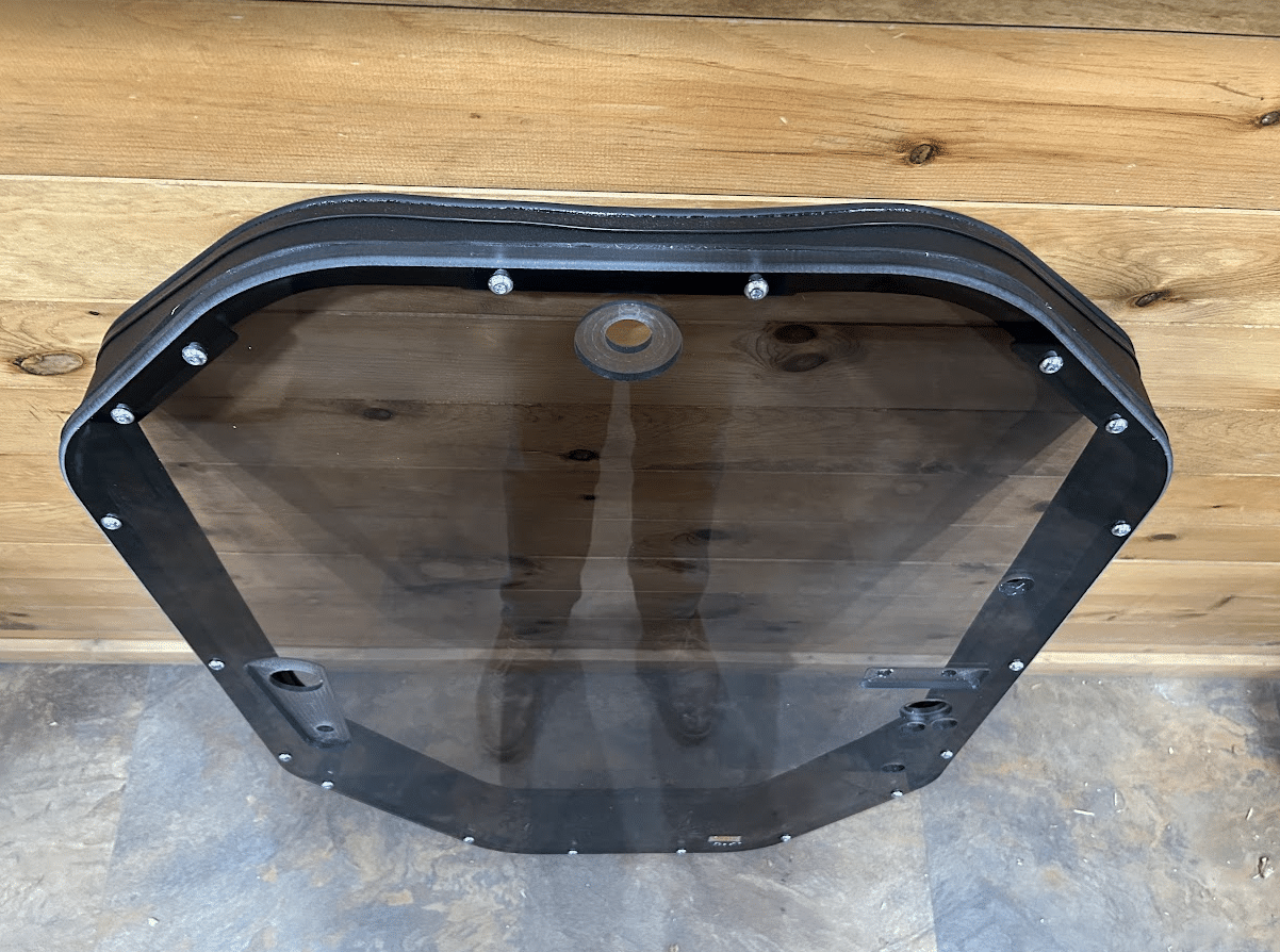 Rear view of tinted John Deere P Series windshield frame assembly showing back of tinted panel and mounting grommet