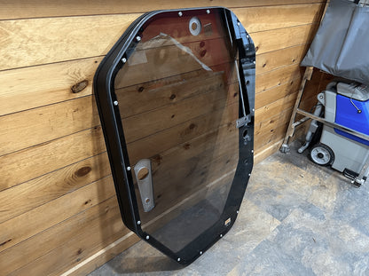 John Deere P Series tinted windshield frame assembly angled view showing red foam door seal strip