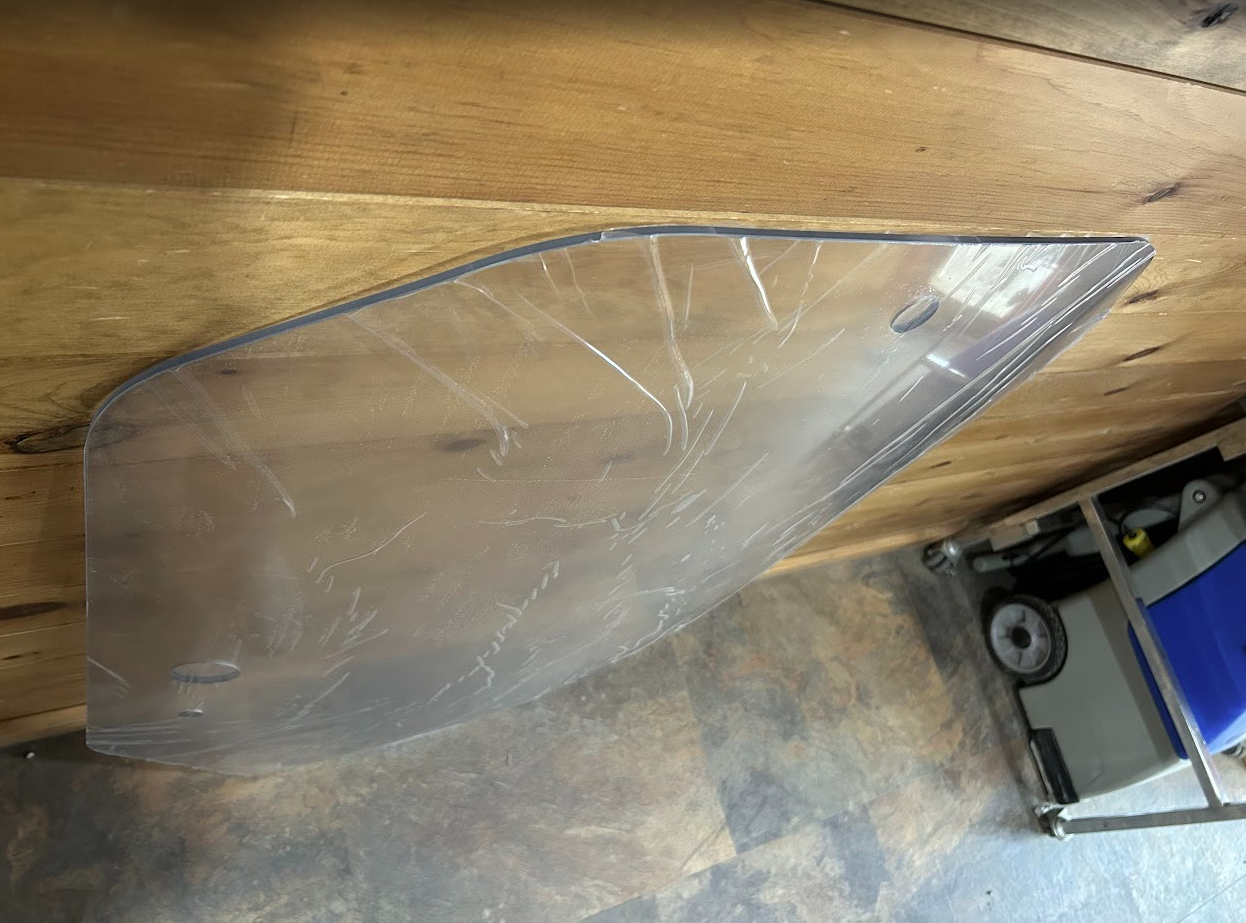 John Deere P Series windshield upper corner edge profile close-up showing curved polycarbonate edge