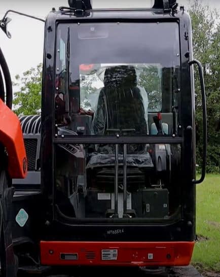 Kubota KX080-4 excavator with polycarbonate windshield installed, front cab view showing upper and lower panels