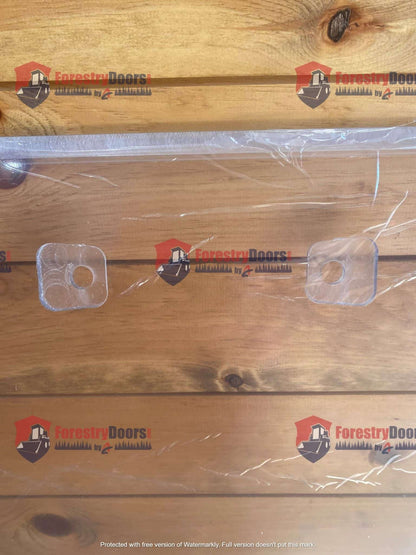 Close-up of Kubota SSV front windshield top edge showing plastic mounting hole covers on the panel surface