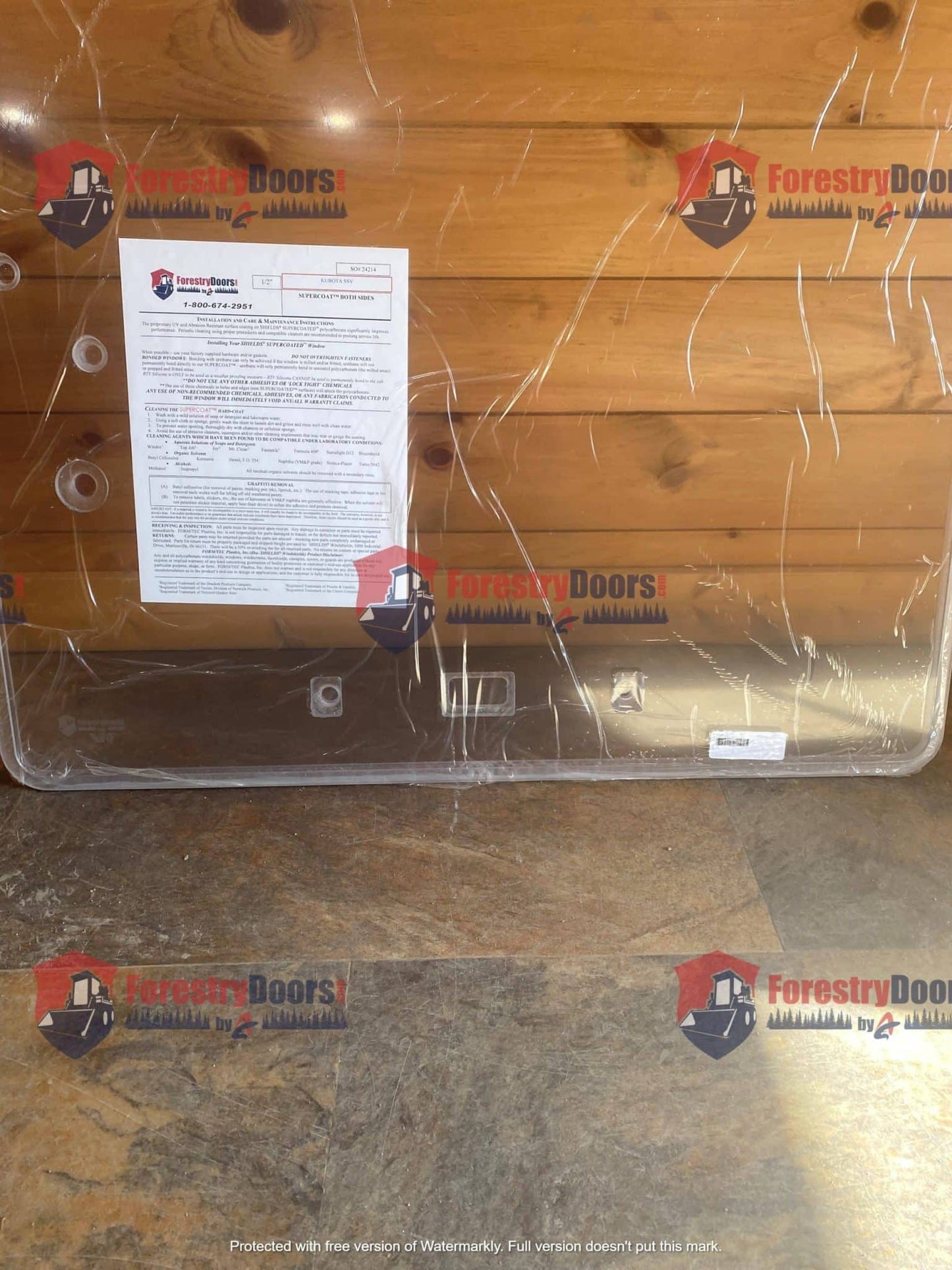 Kubota SSV front windshield panel back view in protective wrap with installation instructions label
