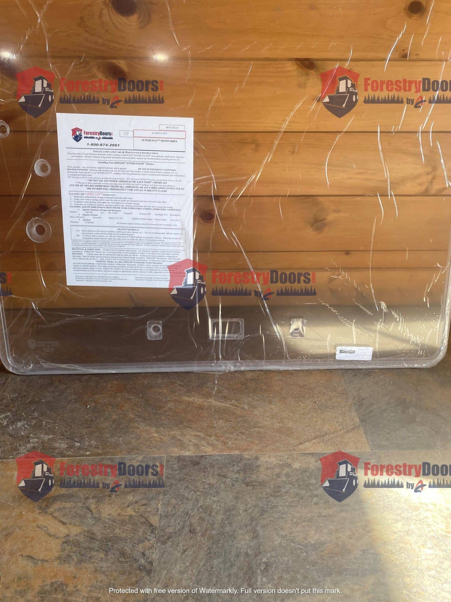 Kubota SSV front windshield panel back view in protective wrap with installation instructions label