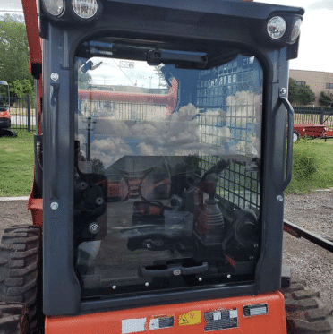 Kubota SSV skid steer cab and polycarbonate windshield viewed from the side showing installed replacement